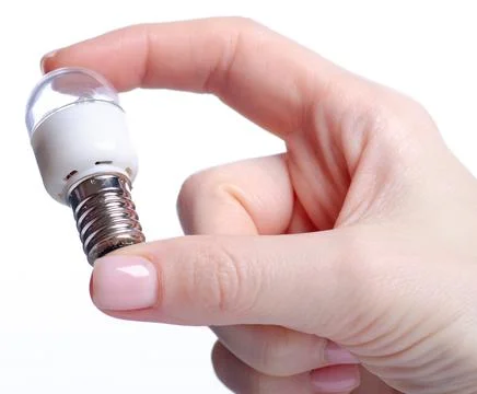 Lamp E14 energy-saving compact fluorescent in hand Stock Photos