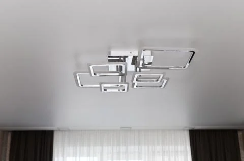 Lamp featuring square chrome frames on ceiling. Stock Photos