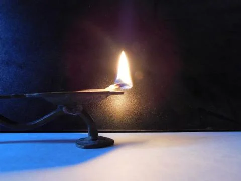 Lamp flame with a dark background Stock Photos