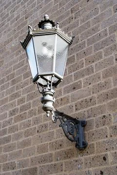 A lamp is hanging from a wall Stock Photos
