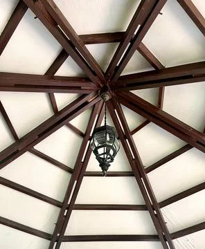 Lamp lantern on ceiling with wooden structure Stock Photos