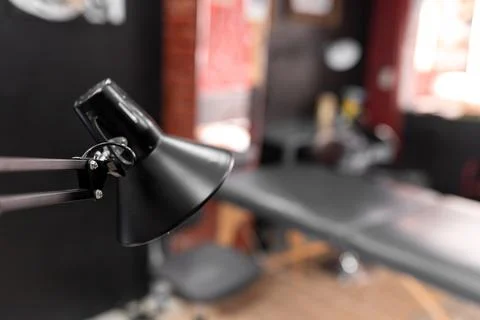 A lamp is lighting an empty tattoo studio Stock Photos