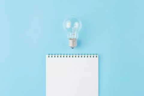 Lamp with notepad on blue background. Foto stock