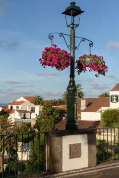 Lamp post on a bridge  adorned by blooming flowes in Nordeste town, Sao Migue Stock Photos
