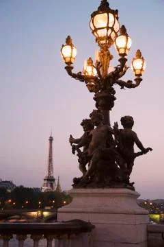 Lamp post with cherubs with Eiffel Tower in background Stock Photos