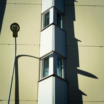 Lamp post leaning into a building Stock Photos