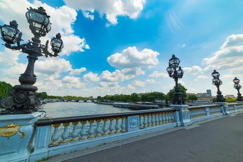 Lamp posts in Alexander III bridge under a cloudy sky 스톡 사진