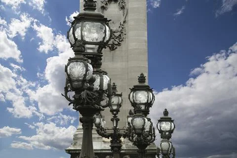 Lamp posts on Alexander III Bridge against the sky with clouds. Paris, France 스톡 사진