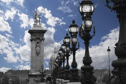 Lamp posts on Alexander III Bridge against the sky with clouds. Paris, France Stock Photos