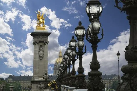 Lamp posts on Alexander III Bridge against the sky with clouds. Paris, France Foto stock