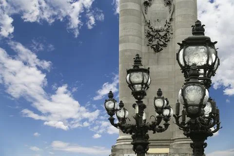 Lamp posts on Alexander III Bridge against the sky with clouds. Paris, France 스톡 사진