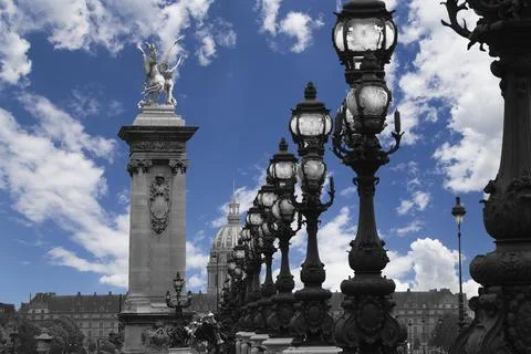 Lamp posts on Alexander III Bridge against the sky with clouds. Paris, France Foto stock