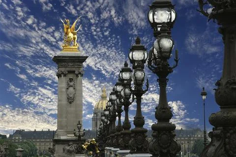 Lamp posts on Alexander III Bridge against the sky with clouds. Paris, France Foto stock
