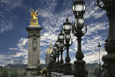 Lamp posts on Alexander III Bridge against the sky with clouds. Paris, France 스톡 사진