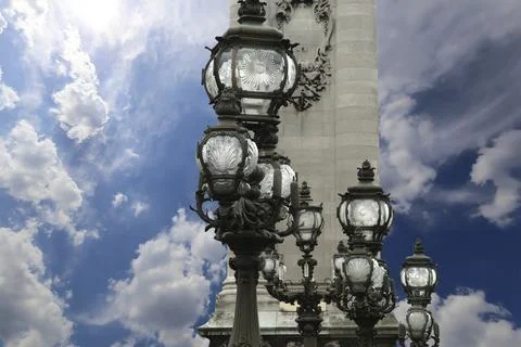 Lamp posts on Alexander III Bridge against the sky with clouds. Paris, France Foto stock