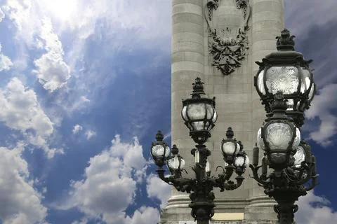 Lamp posts on Alexander III Bridge against the sky with clouds. Paris, France 스톡 사진