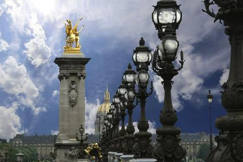 Lamp posts on Alexander III Bridge against the sky with clouds. Paris, France Stock Photos