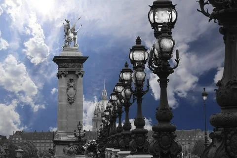 Lamp posts on Alexander III Bridge against the sky with clouds. Paris, France Foto stock
