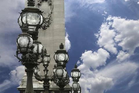 Lamp posts on Alexander III Bridge against the sky with clouds. Paris, France Foto stock