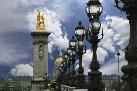 Lamp posts on Alexander III Bridge against the sky with clouds. Paris, France 스톡 사진