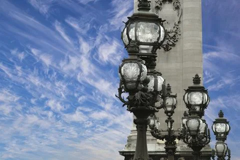 Lamp posts on Alexander III Bridge against the sky with clouds. Paris, France Foto stock