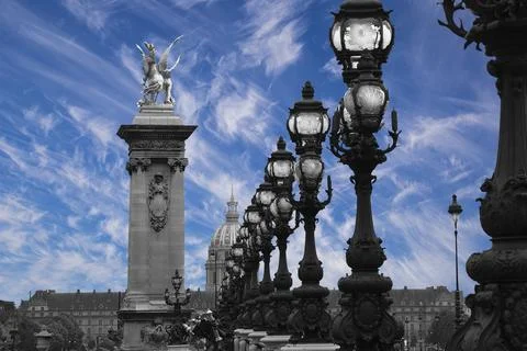Lamp posts on Alexander III Bridge against the sky with clouds. Paris, France Stock Photos
