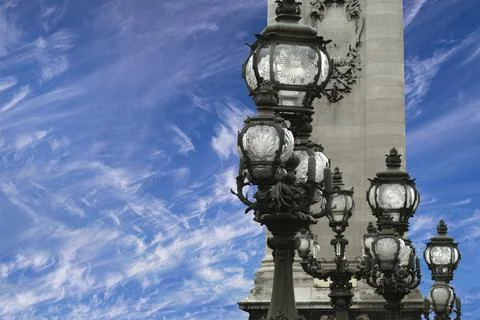 Lamp posts on Alexander III Bridge against the sky with clouds. Paris, France Foto stock