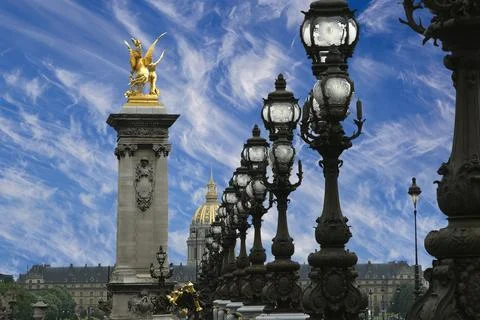 Lamp posts on Alexander III Bridge against the sky with clouds. Paris, France 스톡 사진