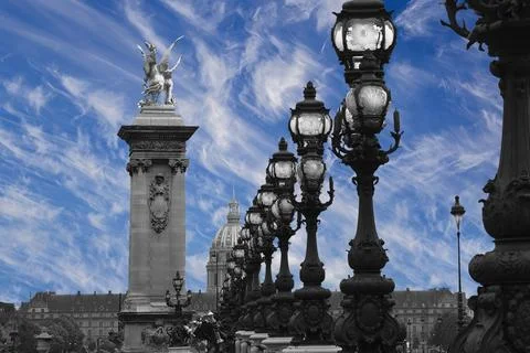 Lamp posts on Alexander III Bridge against the sky with clouds. Paris, France Stock Photos