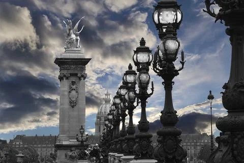 Lamp posts on Alexander III Bridge against the sky with clouds. Paris, France Foto stock