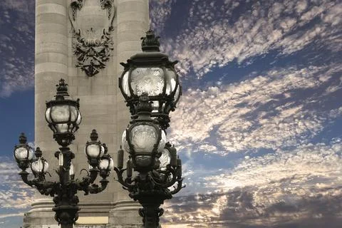 Lamp posts on Alexander III Bridge against the sky with clouds. Paris, France 스톡 사진