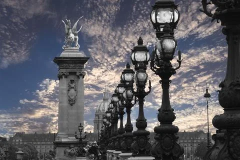 Lamp posts on Alexander III Bridge against the sky with clouds. Paris, France Foto stock