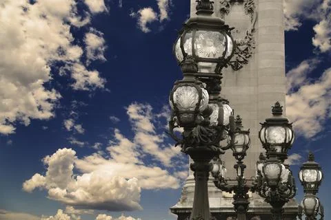 Lamp posts on Alexander III Bridge against the sky with clouds. Paris, France 스톡 사진