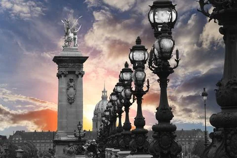 Lamp posts on Alexander III Bridge against the sky at sunset. Paris, France Foto stock