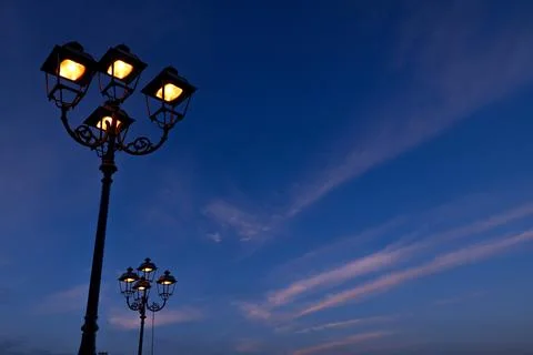 Lamp Posts Glow In The Night Sky - ITALY Stock Photos
