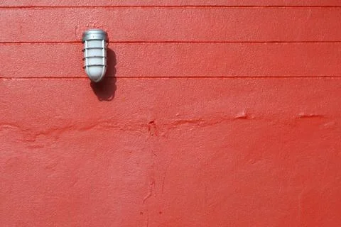 Lamp on the red wall Stock Photos