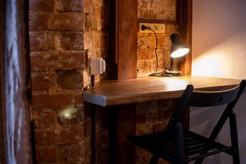 A lamp on a small desk Stock Photos