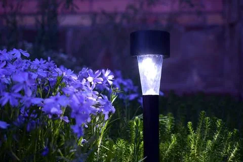 Lamp on the solar panel in the garden. Stock Photos