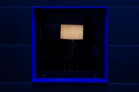 Lamp in a square blue window Stock Photos