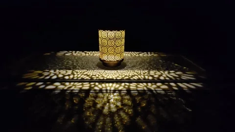 Lamp on the table at night. Yellow textures created by the shape of the lamp Stock Footage 222988250
