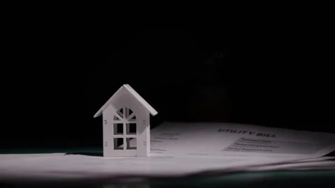 The lamp turns off against the backdrop of the utility bill and the house, .. Stock Footage 304137693