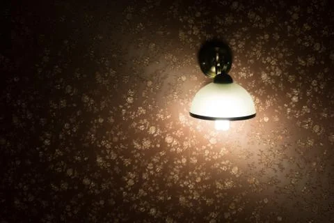 Lamp on a wall shining Stock Photos