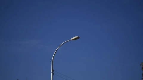 Lampost Light with completely blue skyn Slow motion Stock Footage 136562873