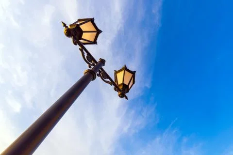Lamppost against the background of the sky with clouds Stock Photos