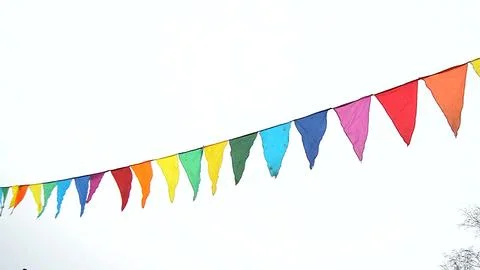 A lamppost and colorful triangular flags fluttering in the wind against an .. Foto stock