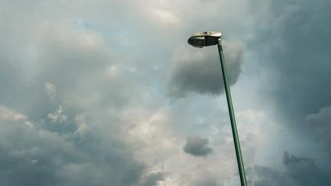 Lamppost on the background of cloudy sky, impending rain Stock Photos