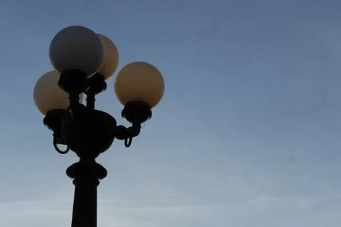 Lamppost in backlight at the left in the sunset Stock Photos