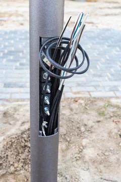 Lamppost with open hole. Inside is a power switch and electrical cables. Elec Foto stock