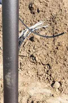 Lamppost with open hole. Inside is a power switch and electrical cables. Elec Photos