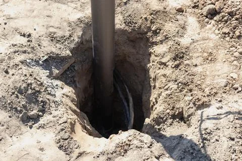 Lamppost with open hole. Inside is a power switch and electrical cables. Elec Foto stock